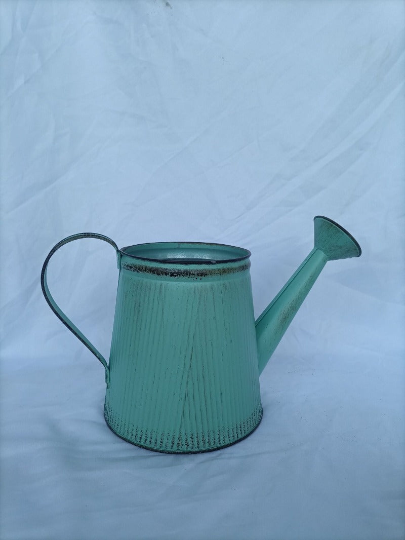 Vintage mint-green metal watering can vase with open top and dark rim