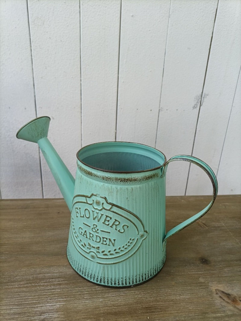 Vintage mint-green metal watering can vase with “Flowers & Garden” emblem and spout
