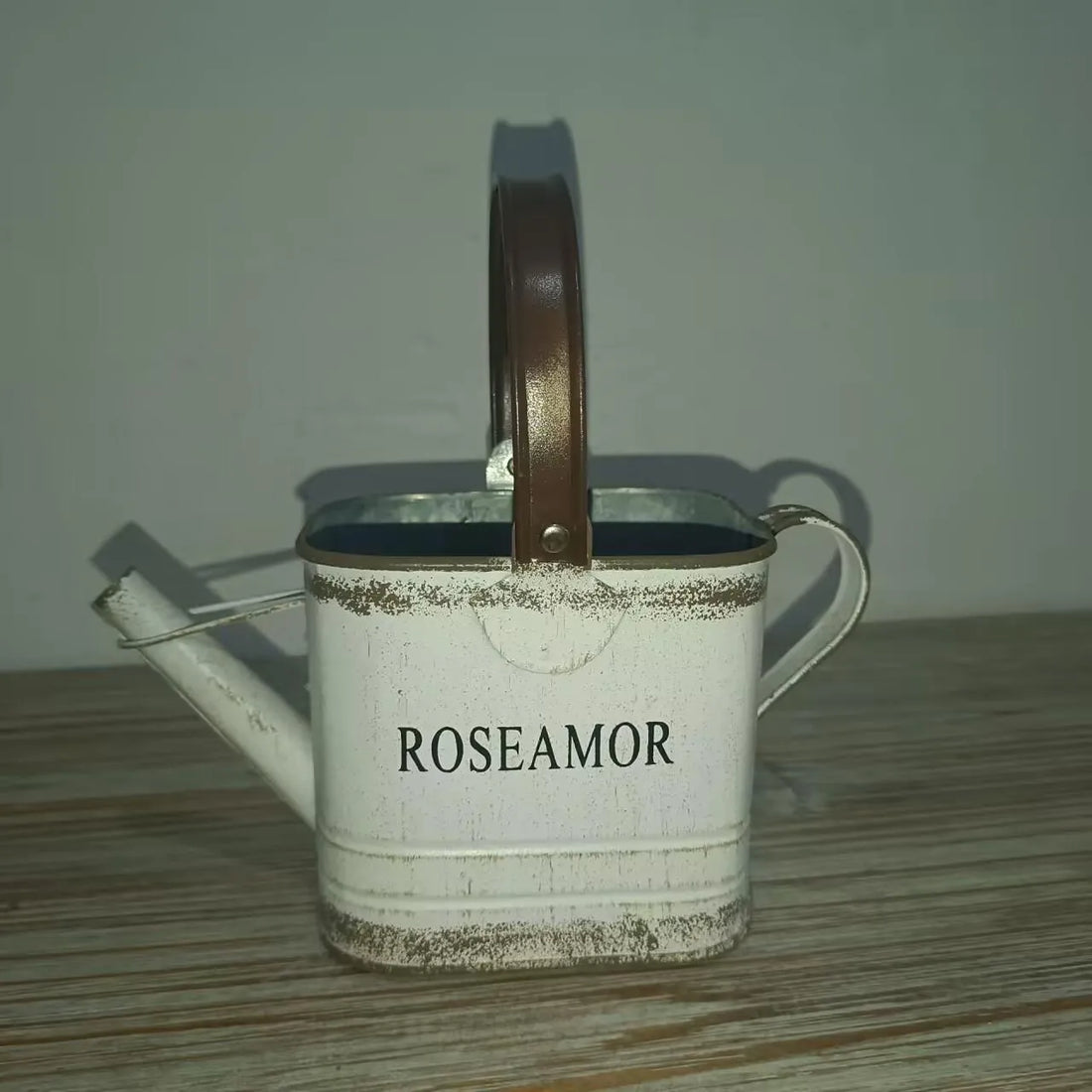 White metal watering can planter with brown handle, ROSEAMOR text on front