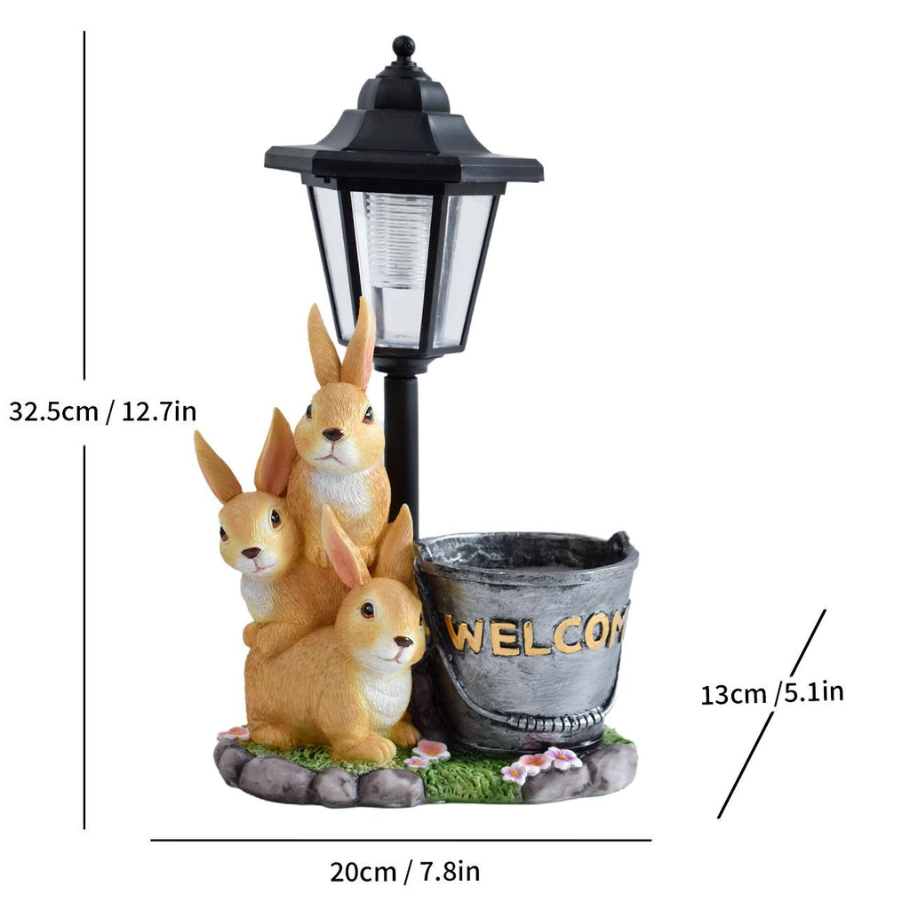 Solar LED lantern garden statue with three rabbits and a stone pot marked “WELCOME�?