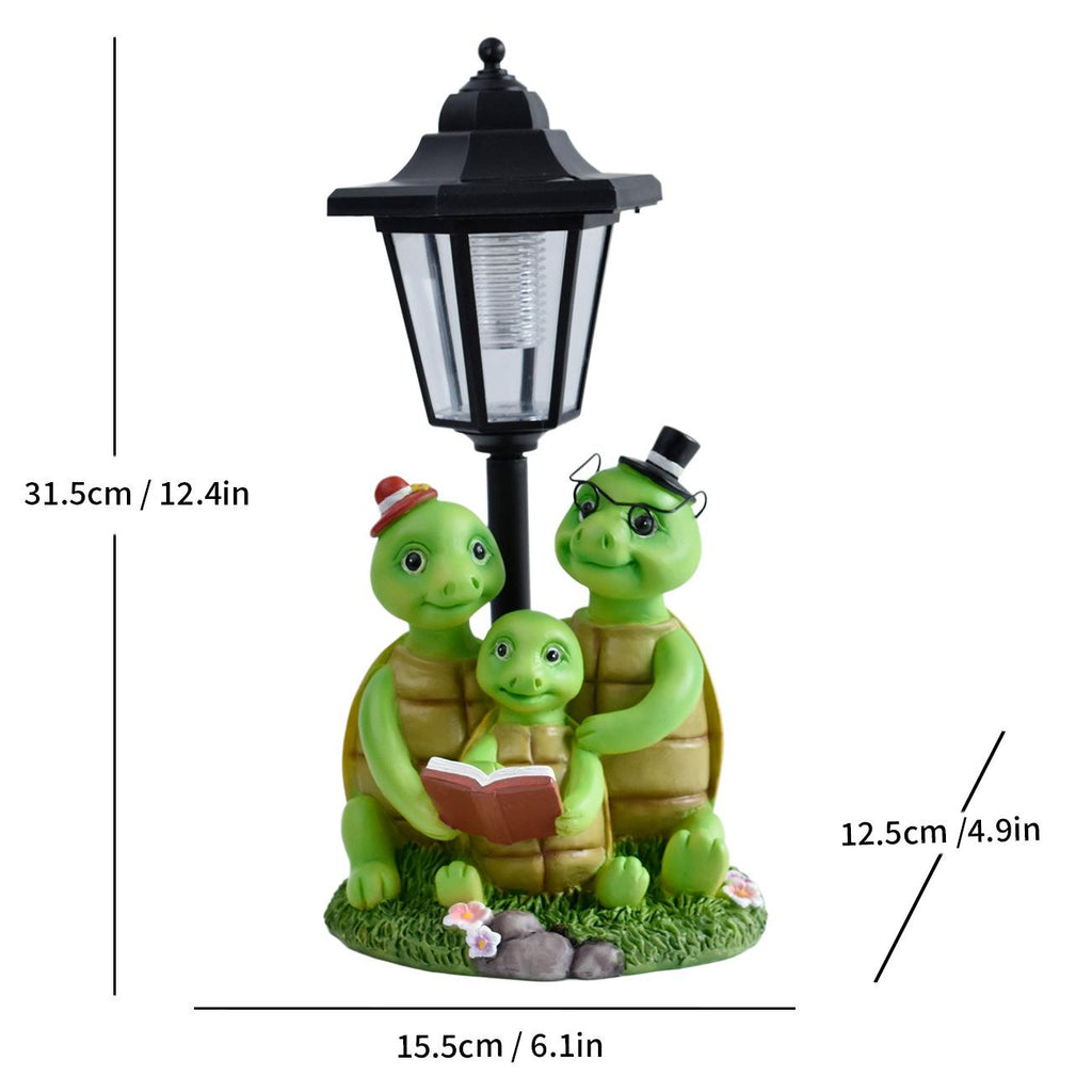 Solar garden animal statue with black lantern and three green turtles around a small book.