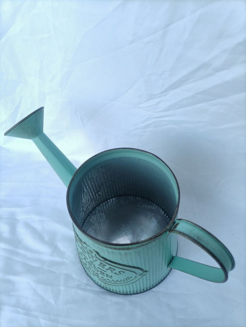 Vintage mint-green metal watering can vase with open top and side handle