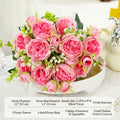 Pink faux peony bouquet on a white pedestal bowl with small green filler blossoms.