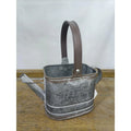 Gray metal watering can planter with brown handle, CHOUETTE label on front