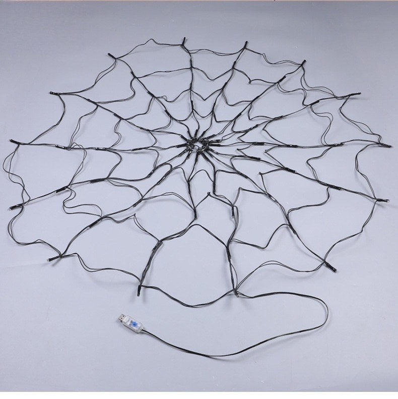 Decoración gigante de telaraña LED con hilos de alambre conectados, luces apagadas.