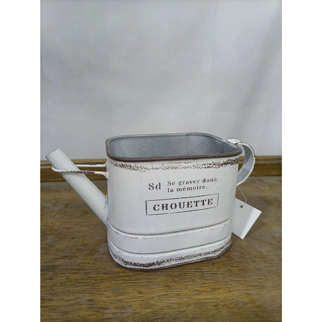 White metal watering can planter with brown handle, CHOUETTE label on front