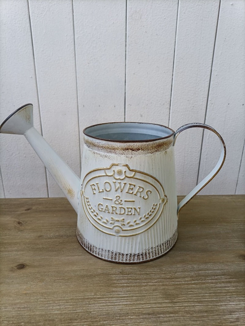 Vintage white metal watering can vase with “Flowers & Garden” emblem and curved handle