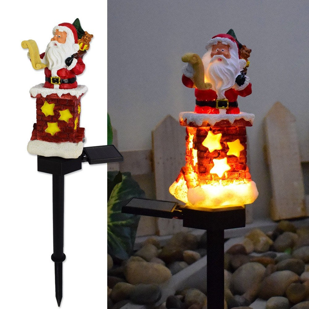 Solar Santa pathway stake light with star decorations and warm glowing stacked base