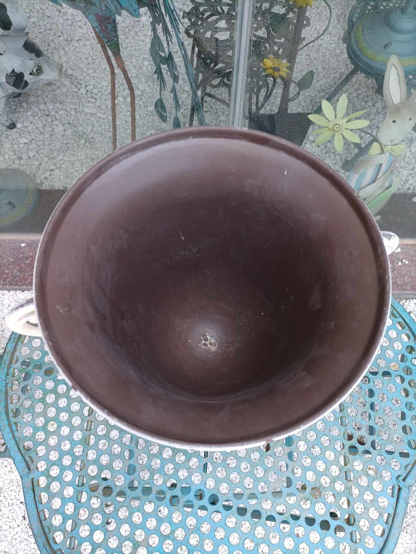 Brown ceramic bowl on a glass table with floral patterns