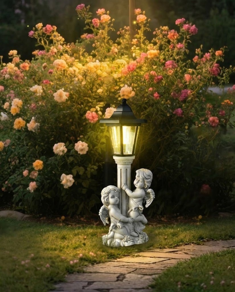 Decorative garden light with cherub figures in front of a flowering bush