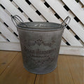 Set Metal bucket with 'Belle Jardinière' text on a wooden floor with white lattice background