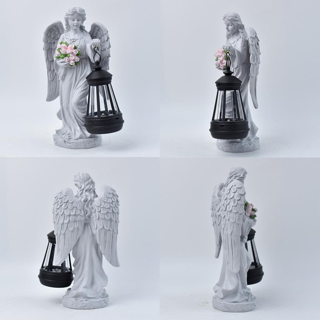 White angel statue with a lantern holding flowers on a white background
