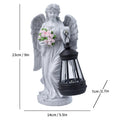 Angel statue with lantern and flowers, showing measurements on a white background