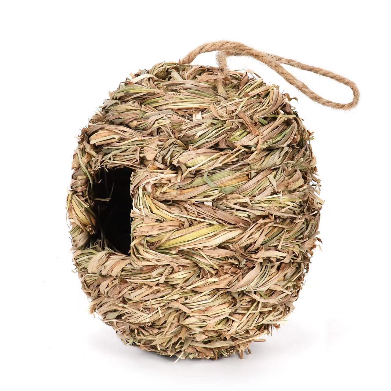 Woven straw ball with a rope on a white background