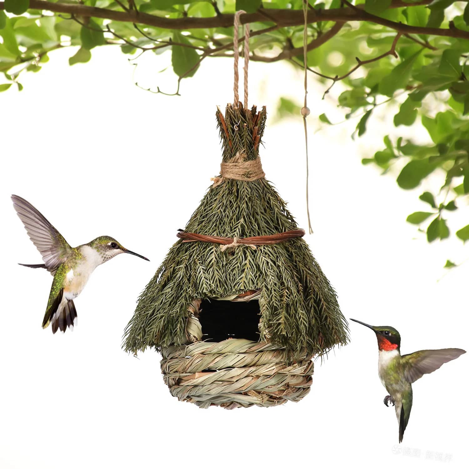 Handmade birdhouse made of natural materials with two hummingbirds in front of it.