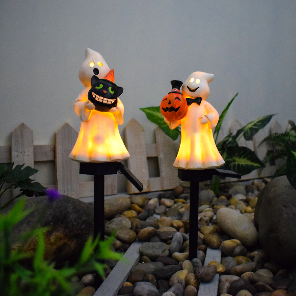 Glödande solcellslampor för trädgården, med katt och spöke, som håller pumpor och jack-o-lantern.