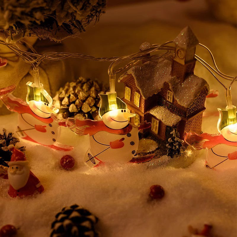 Warm-white LED light string with glowing snowman, house, and holiday figures