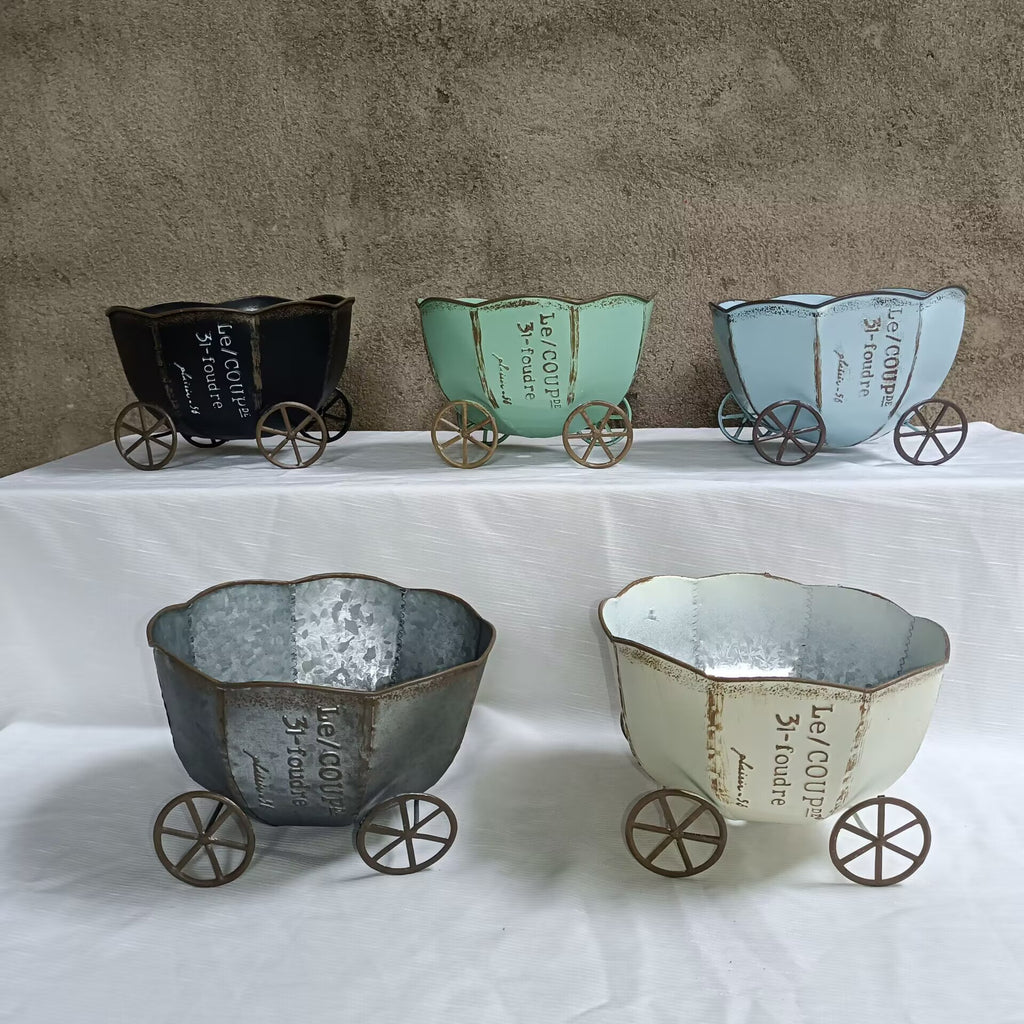 Set of four vintage metal cart planters in assorted finishes on wheels