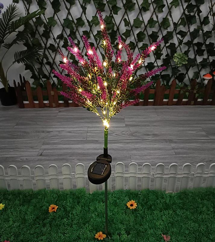 Solar garden stake light with glowing yellow bulbs, pink-purple tips, round base box