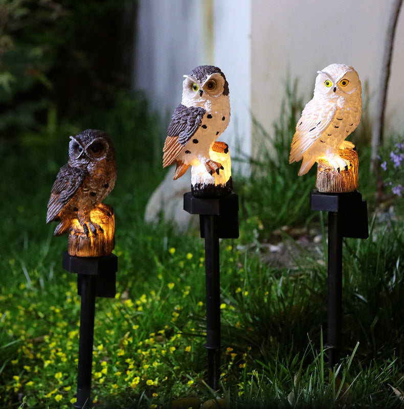 Three hand-painted owl solar garden stake lights with warm glow, black bases
