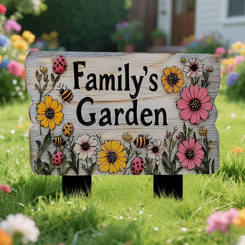 Floral wooden yard stake sign reading Family's Garden, with bright flowers and ladybugs