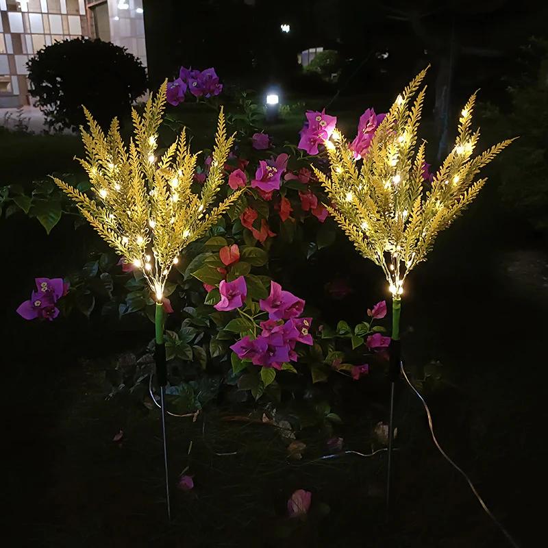 Set of two solar pathway stake lights with bright yellow-white glow and lavender tips
