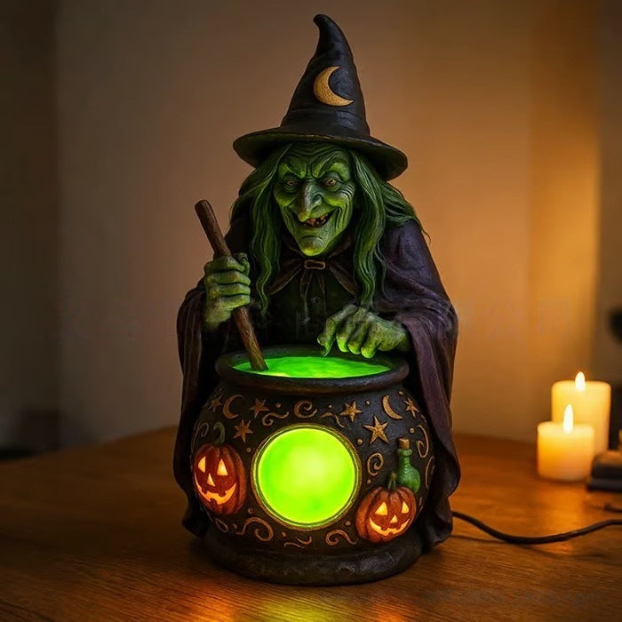 Halloween-heksebordlampe i harpiks med glødende grøn kugle og græskarlygtedetaljer
