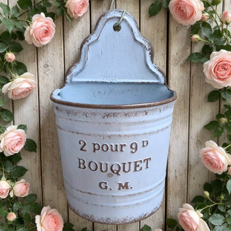 Light blue distressed metal wall pocket planter with hanging hook and text