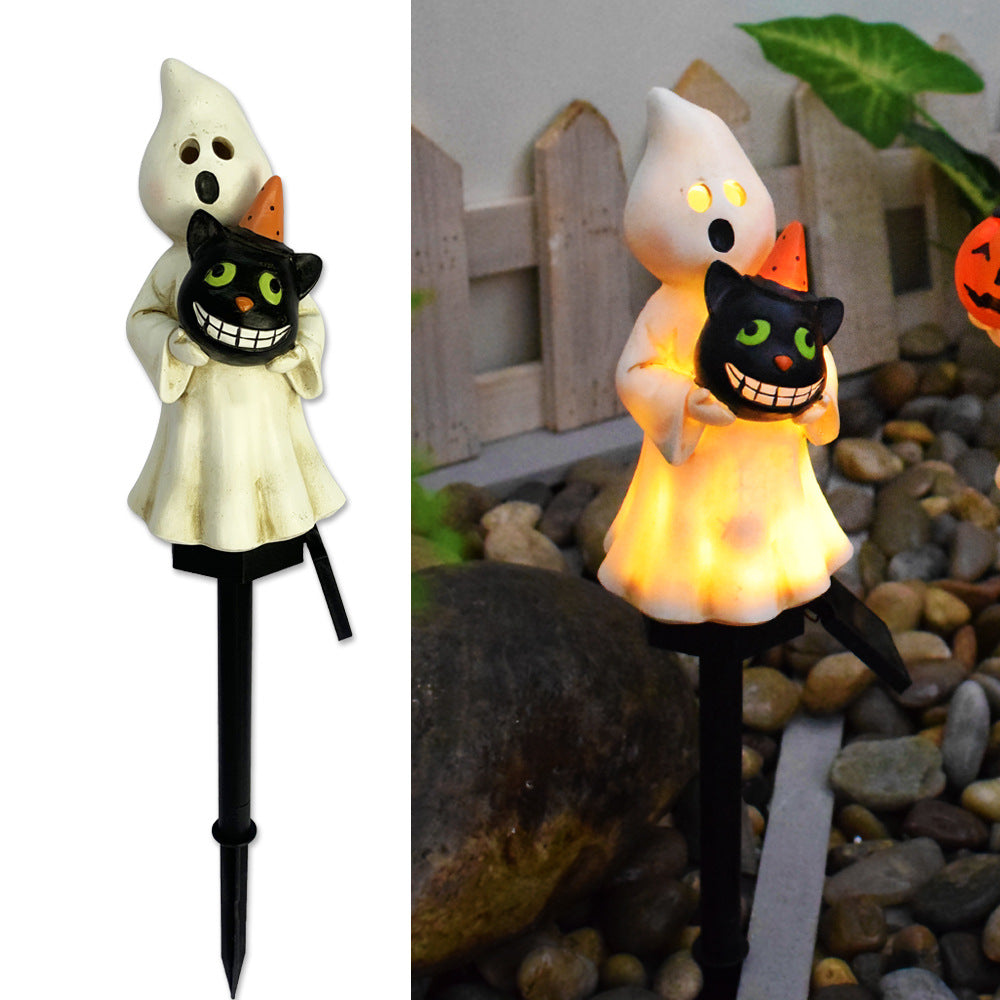 Glödande spök- och svart katt-solcellslampor för trädgården med jack-o-lantern-accenter
