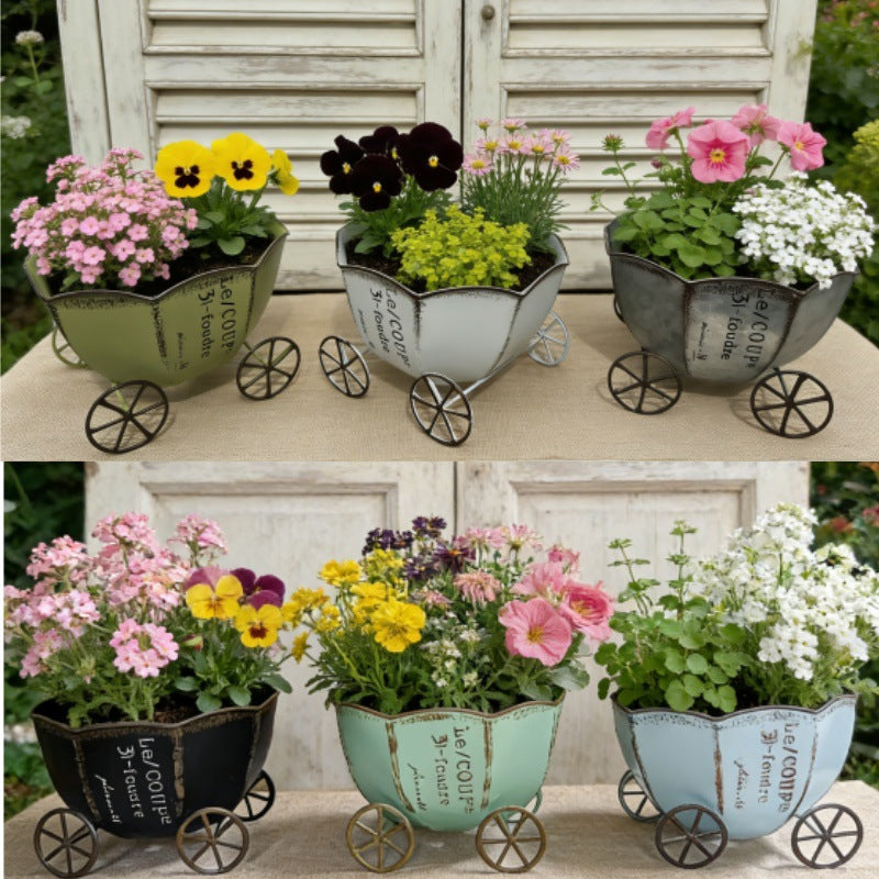 Vintage metal cart planters with wheels, holding colorful flowers