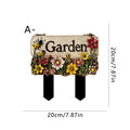 Floral wooden yard stake sign reading Garden, on two black stakes