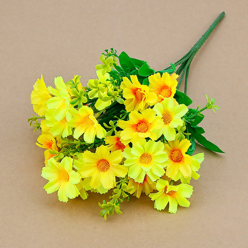 Artificial wildflower stems with yellow faux daisies and green leaves