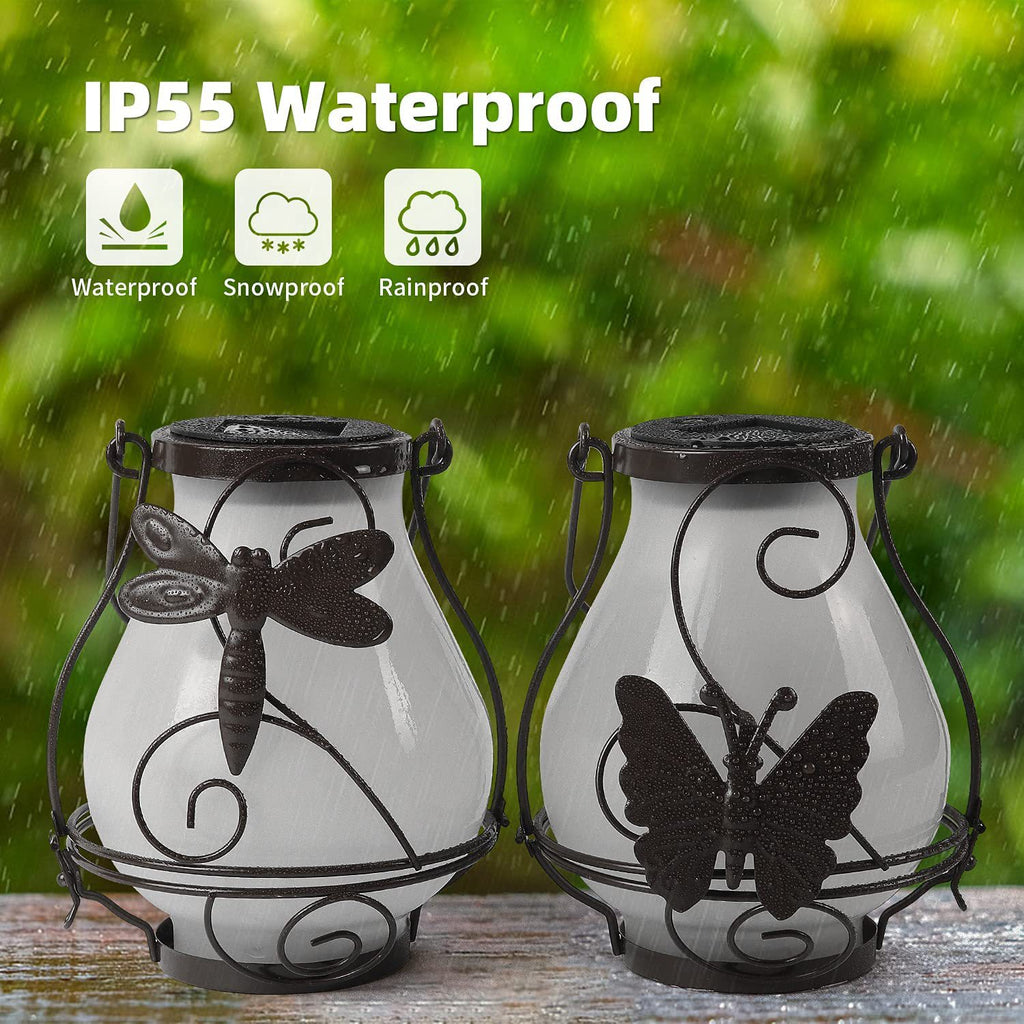 Pair of frosted solar flame lanterns with black metal frames and butterfly silhouettes