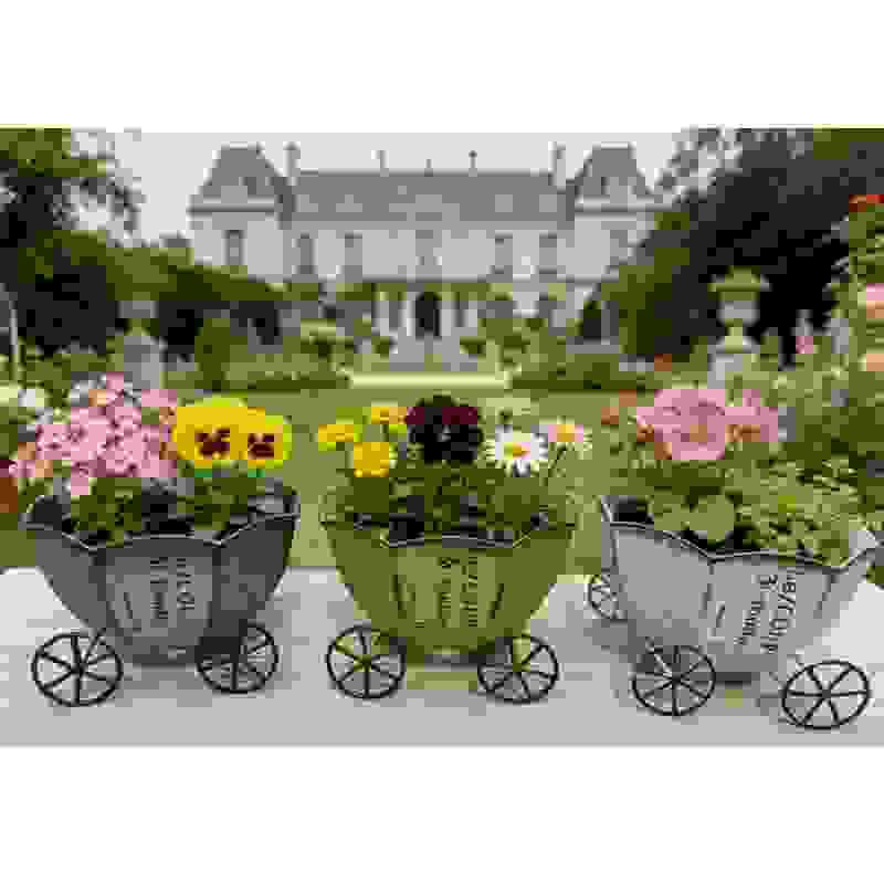 Vintage metal cart planters with wheels holding mixed flowers
