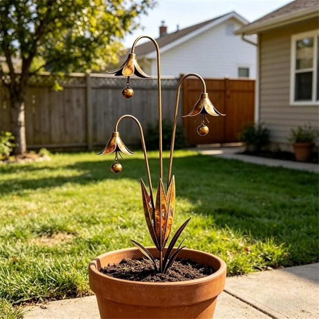Copper-tone metal garden stake with three bellflower heads, hanging beads, and decorative base