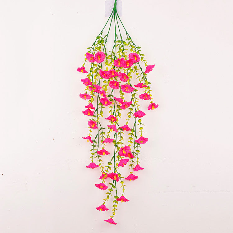 Hanging artificial morning glory vine with bright pink flowers and trailing green leaves