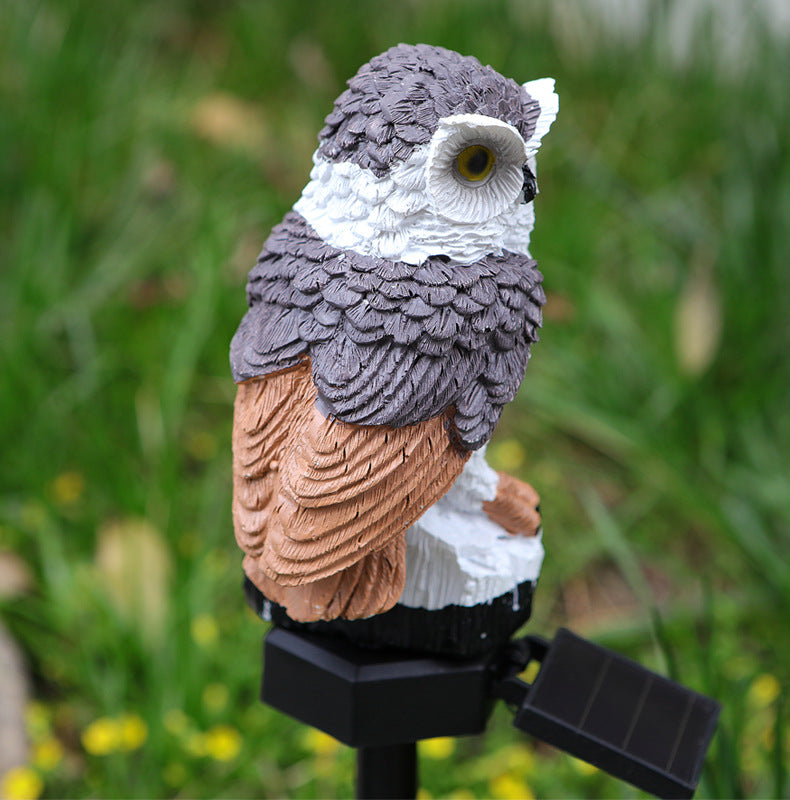 Solar owl garden stake light, perched owl with gray head and tan wing on black stake