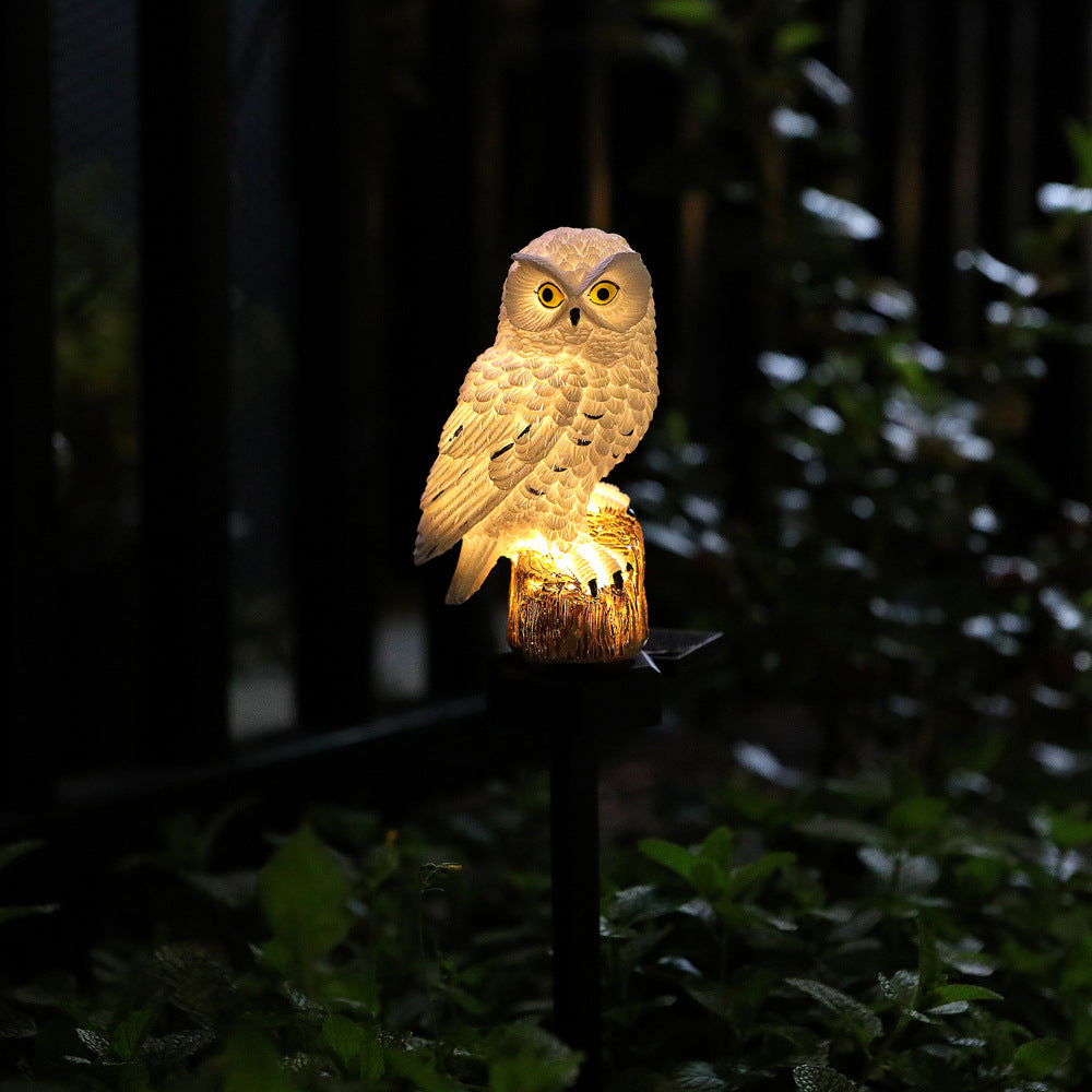 Single golden owl solar garden stake light with warm glow in dark garden