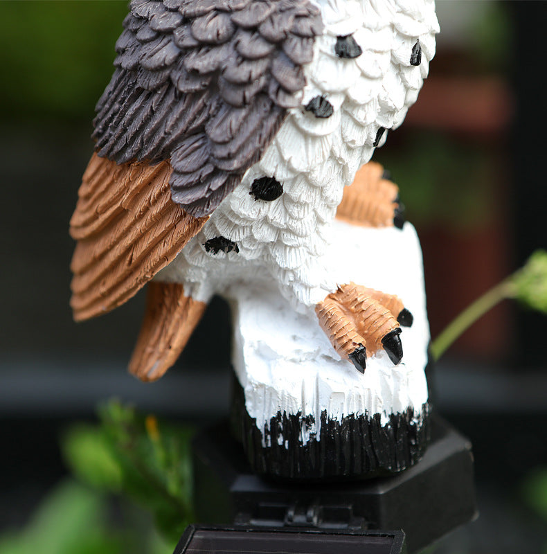 Textured resin owl garden stake topper with orange-brown and white feathers, black base