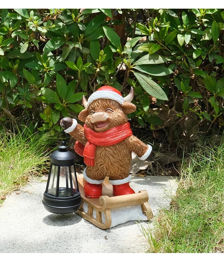 Hand-painted cow solar lantern statue sitting on sleigh, red scarf, white hat and lantern