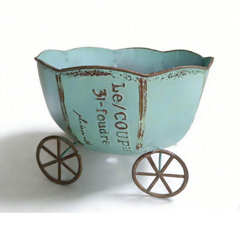 Teal vintage metal cart planter with wheels and printed text