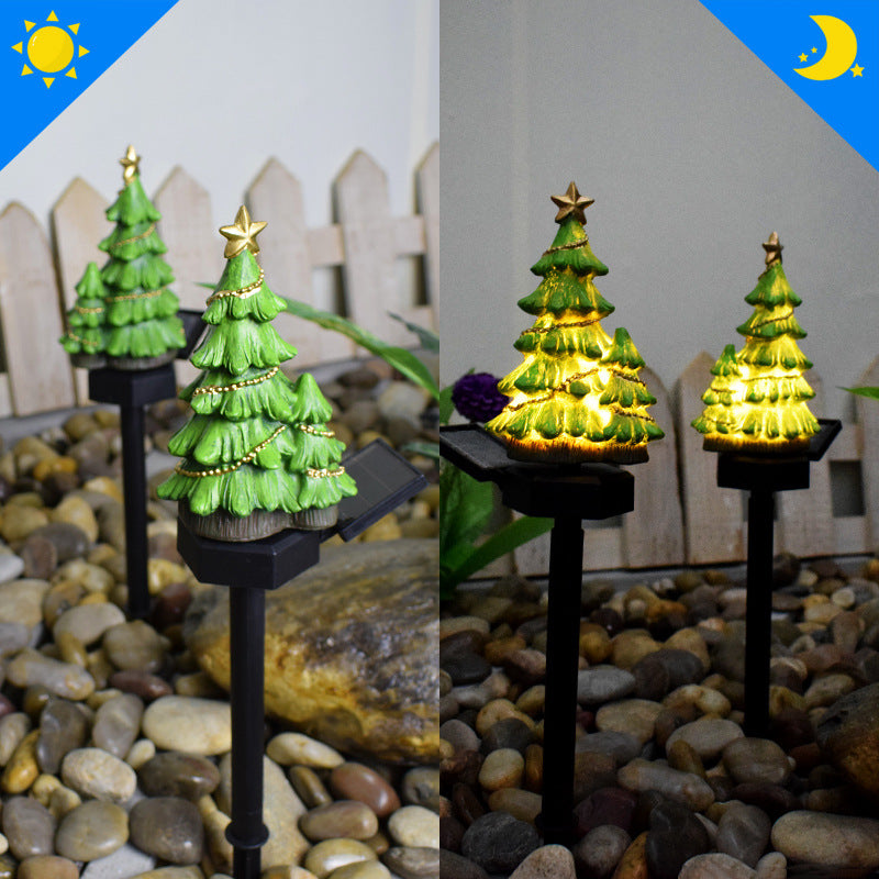 Solar Christmas tree-themed light-up pathway stakes on dark stake bases.