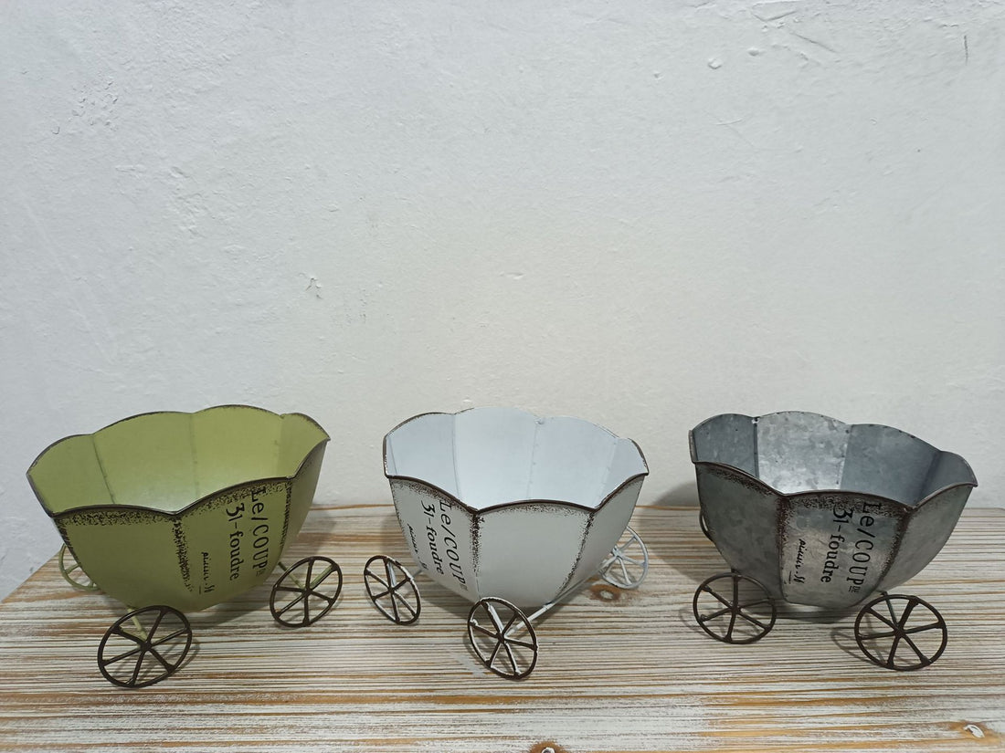 Set of three vintage metal cart planters in green, white, and silver tones