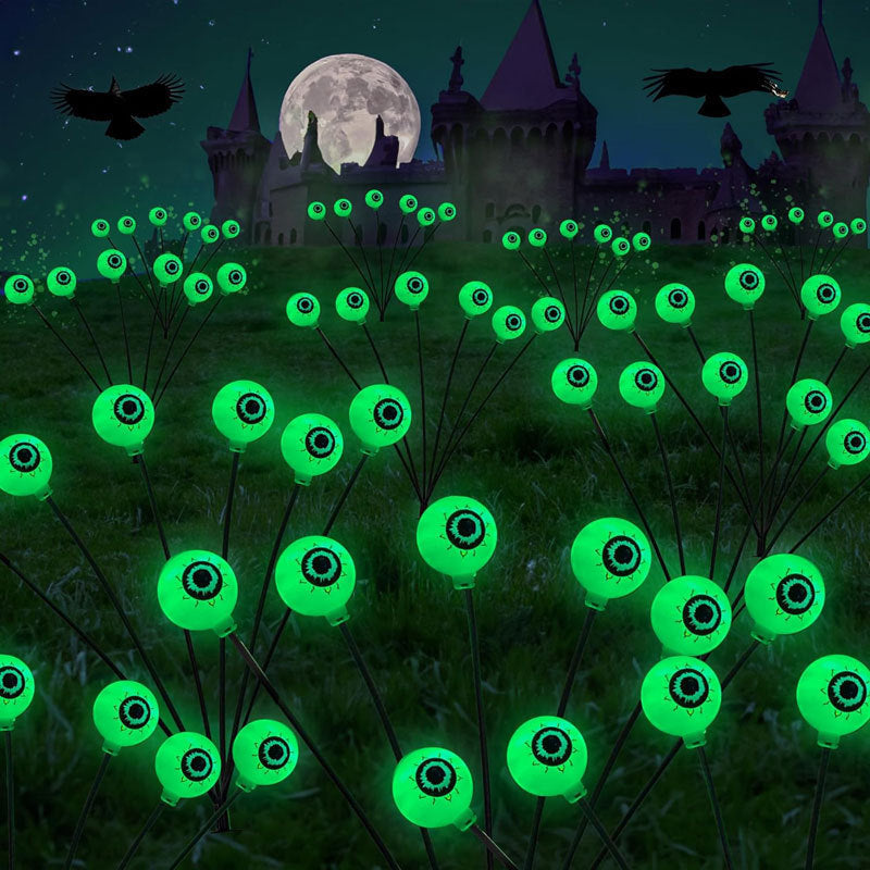 Luces solares espeluznantes de ramas con ojos verdes y luces LED en estacas para jardín.