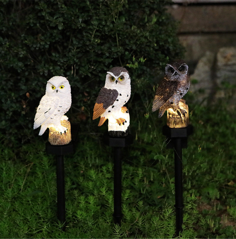 Three owl solar garden stake lights with warm glow, one dark brown, one white