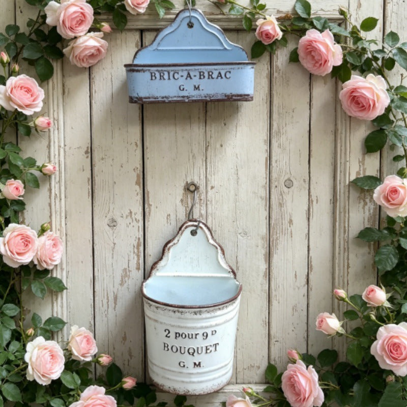 Light blue distressed metal wall planter with top hanger and bouquet text