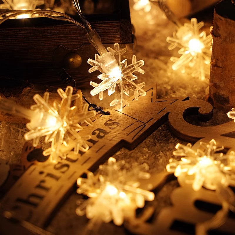 Golden LED string lights with glowing snowflake ornaments