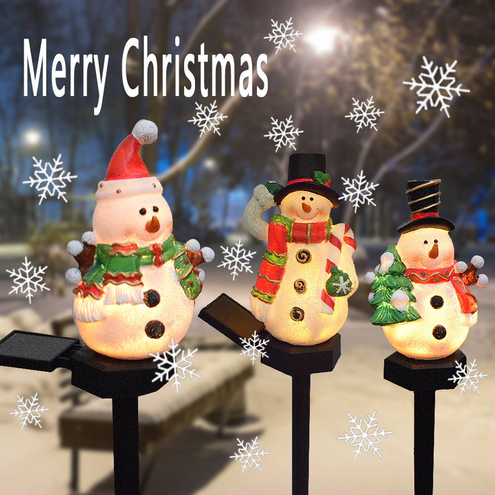 Solar Christmas snowman and Santa light-up pathway stake set with three figures.