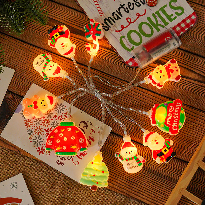 LED string lights with glowing gingerbread, Santa, nutcracker, and tree character charms