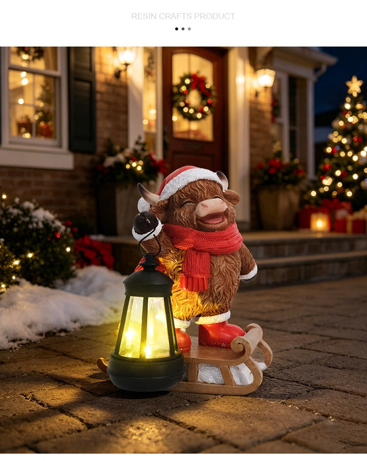 Cow rocking sleigh Christmas solar lantern statue with warm glowing lantern in snowy setting